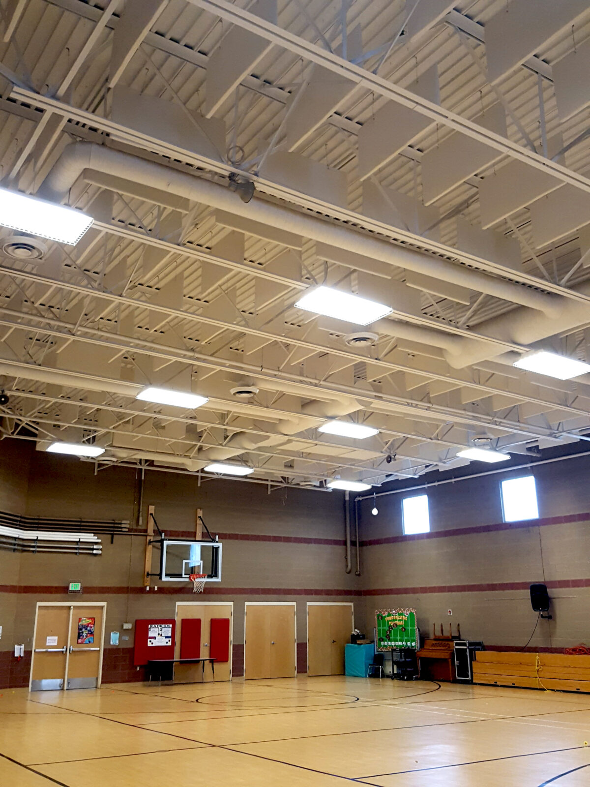 White VET Baffles hanging from gym ceiling