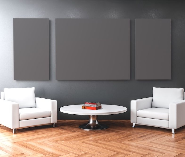 Dark gray painted acoustical panels on wall