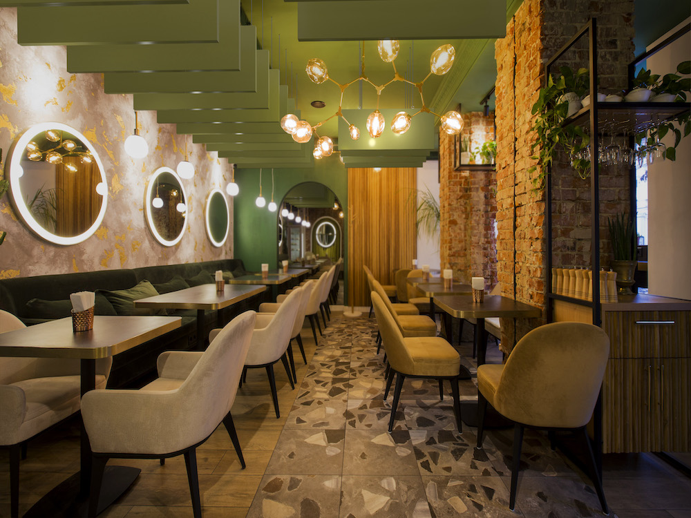 Green painted acoustic baffles hanging from the ceiling in a restaurant