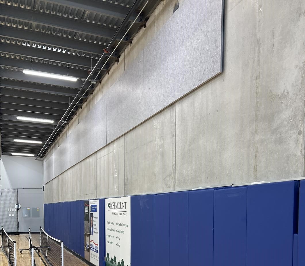 Acoustic felt panels on concrete gym wall