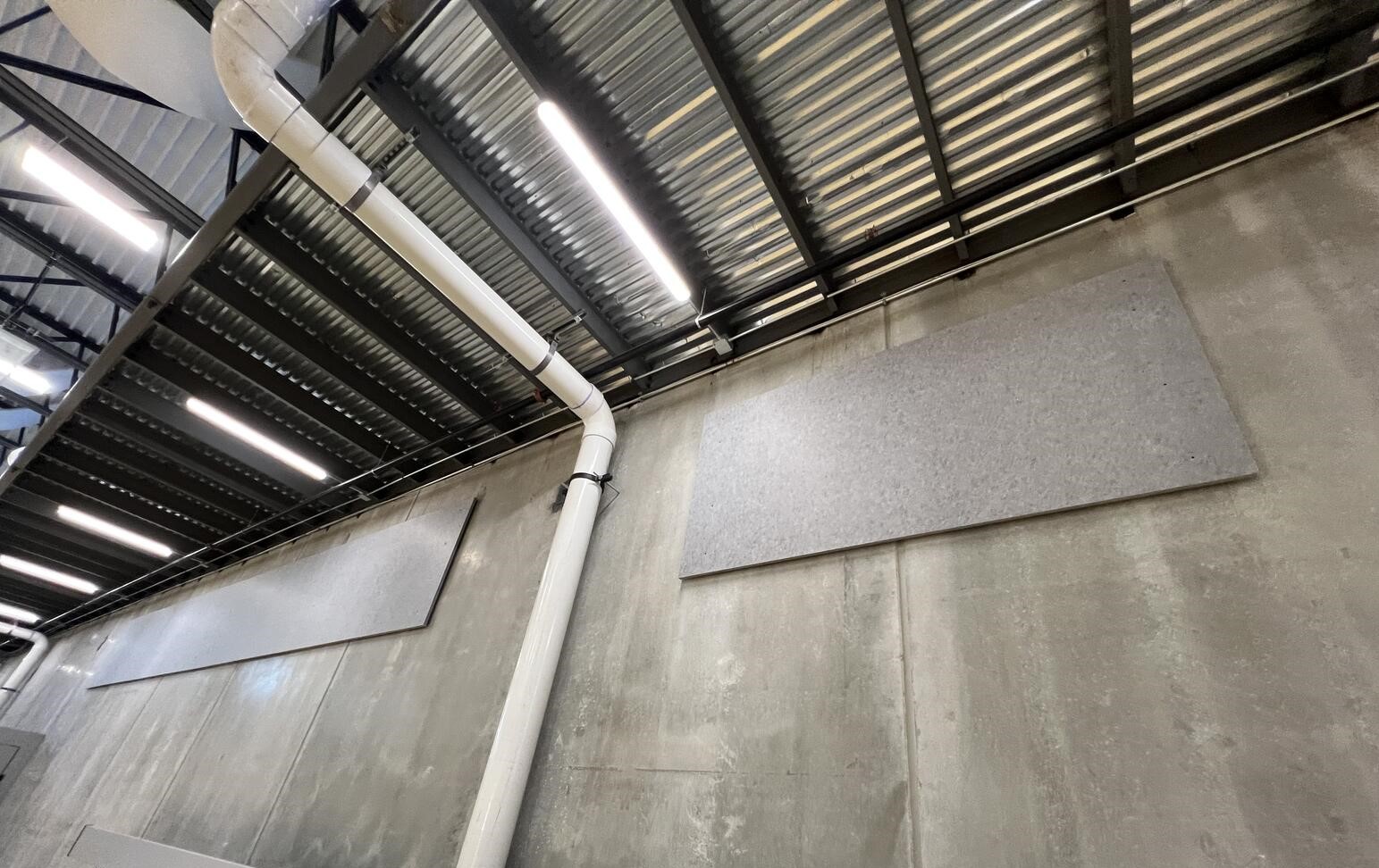 Acoustic felt panels in heather gray attached to concrete wall