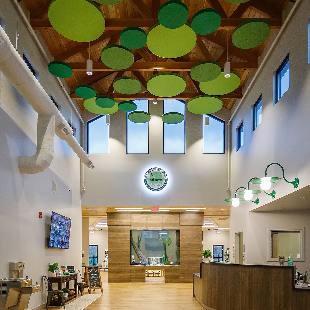 Green circular acoustic felt clouds in a lobby